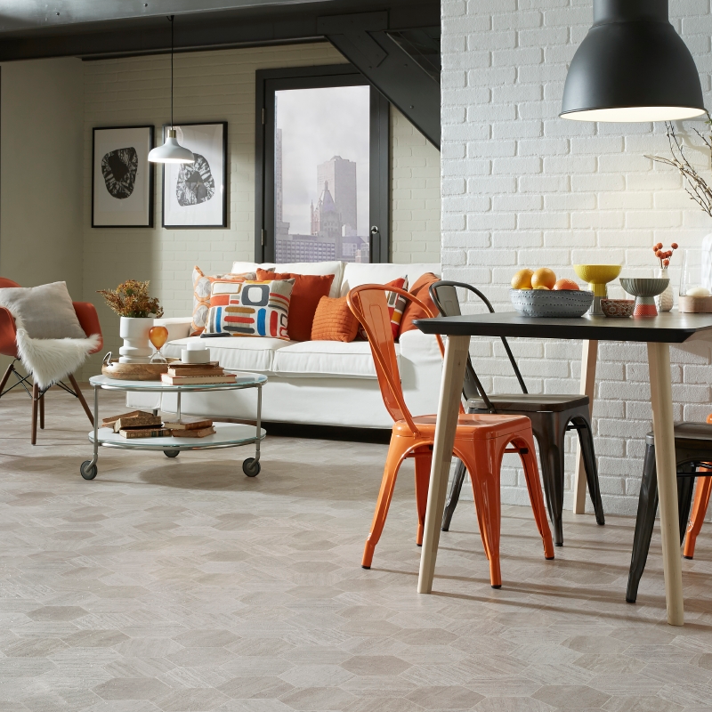 Residential Laminate Flooring In A Kitchen Space With A Table, Couch & Chairs